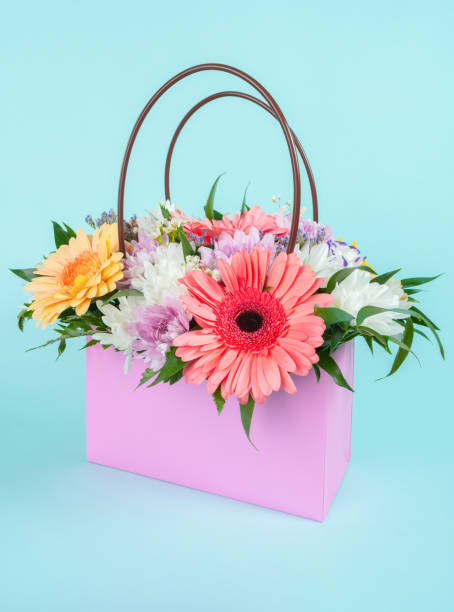 istock Flowers bouquet in a gift bag. 1423010284