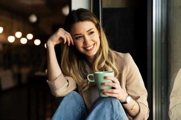 istock Businesswoman drinking coffee in the office 1423010373