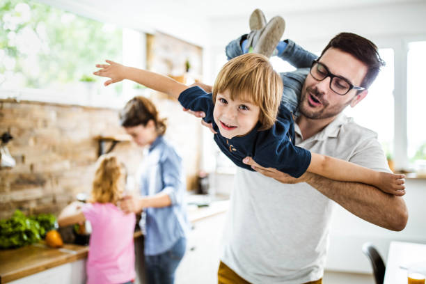 istock Happy boy having fun with his father in the kitchen. 1423010524