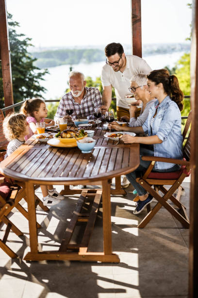 istock Happy multi-generation family talking while having a meal on a terrace. 1423010609