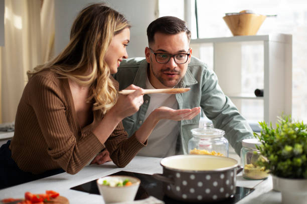 istock Boyfriend and girlfriend cooking together. 1423010807