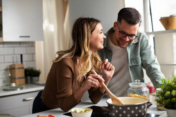 istock Boyfriend and girlfriend cooking together. 1423010810