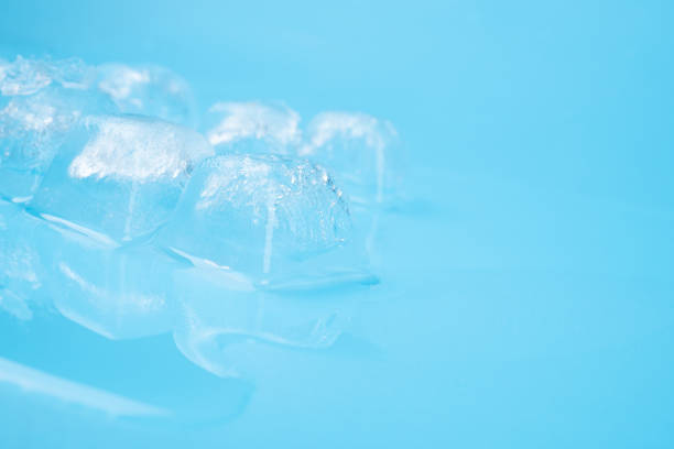 clear frost ice cubes on blue background.