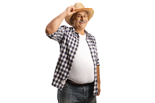 Mature farmer smiling and greeting with his straw hat isolated on white background