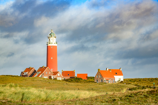 Lighthouse at the Wadden island Texel in the dunes during a stormy autumn morning. The Eierland lighthouse is located at the North point of the island.