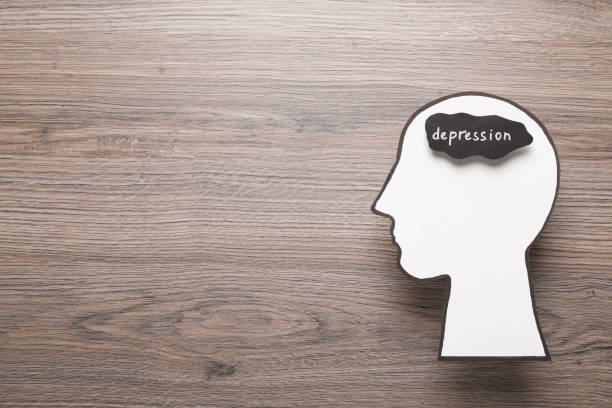 istock Human head cutout with word Depression on wooden table, top view. Space for text 1423014288