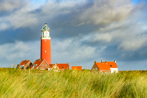 Banner of lighthouse with dunes. BlåvandLighthouse against blue sky with dune at the Danish North Sea coast in vintage style, Blåvandshuk Fyr, Jutland, Denmark, Europe.