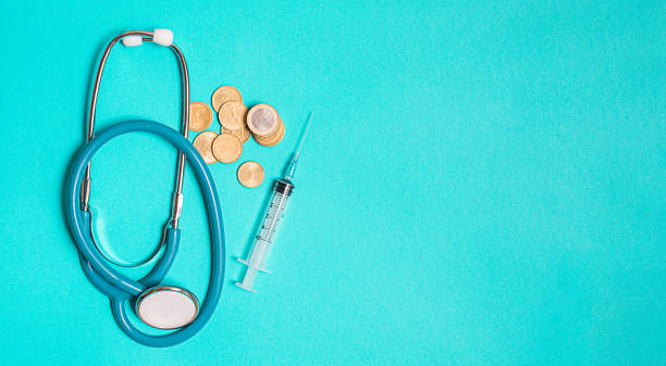 istock Syringe with vaccine on blue background from above 1423014740