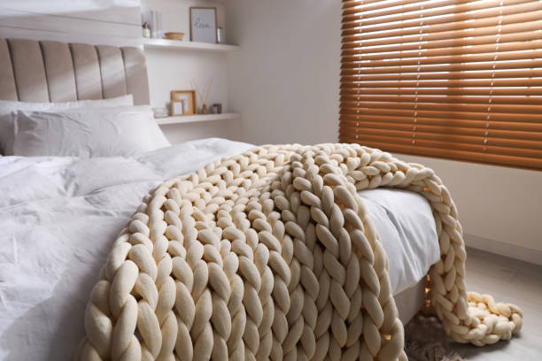 istock Soft chunky knit blanket on bed indoors 1423015367