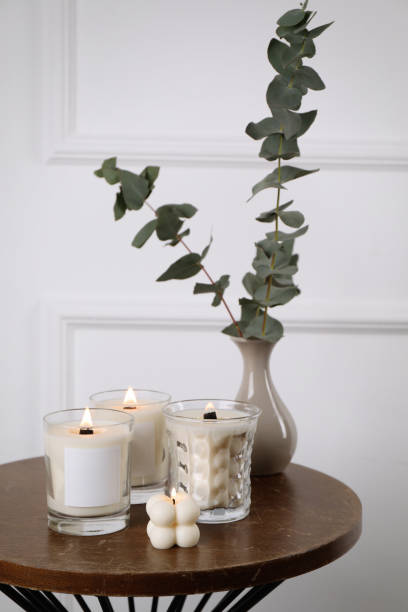 istock Different soy candles and eucalyptus on wooden table indoors 1423015370