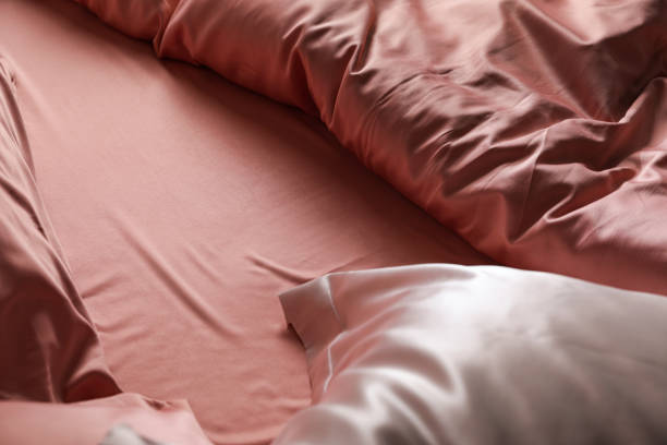 istock Closeup view of bed with beautiful silk linens 1423015521