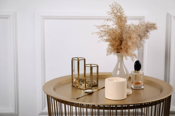 istock Burning soy candle, perfume and stylish accessories on table indoors. Space for text 1423015580
