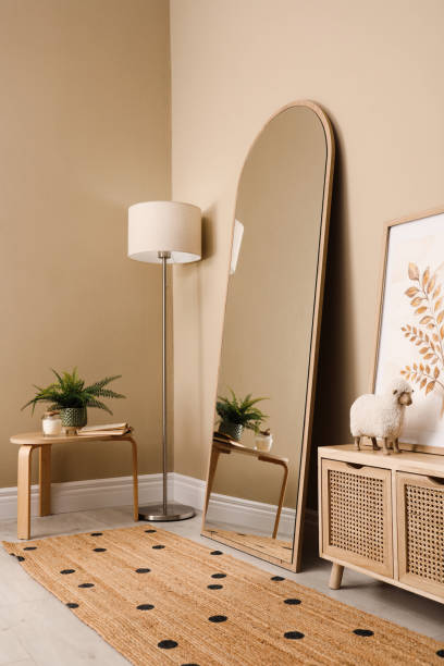 istock Beautiful mirror and console table near beige indoors. Interior design 1423016625