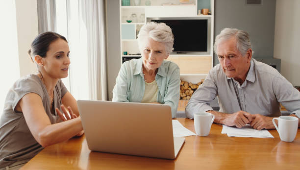 financial advisor, retired couple and a laptop, consulting over a contract. elderly man and woman meeting a consultant, talking budget for insurance, banking or planning an investment in retirement. - finance senior adult financial advisor meeting imagens e fotografias de stock