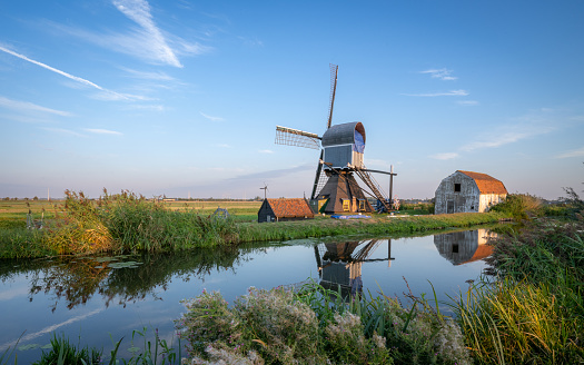 A collection of 18th Century traditional Dutch windmills, at sunset at Kinderdijk in South Holland.
