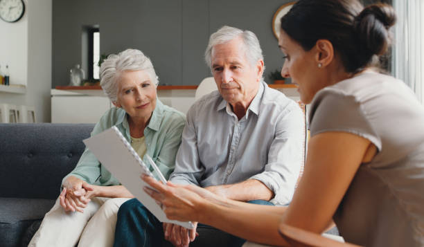 Financial advisor, senior couple and finance paper with savings budget, investment growth and retirement loan. Healthcare insurance, medical security and tax planning for elderly in home living room asesor financiero, pareja senior y papel financiero con presupuesto de ahorro, crecimiento de la inversión y préstamo para la jubilación. seguro de salud, seguridad médica y planificación fiscal para ancianos en la sala de estar del hogar