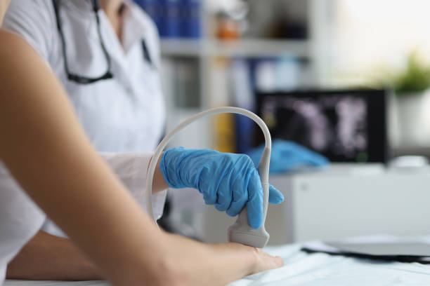 Doctor makes ultrasound of wrist in clinic closeup stock photo