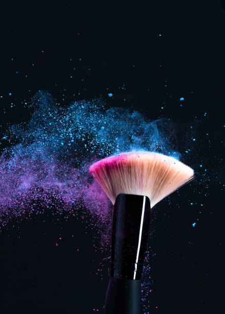istock Makeup powder scattering from makeup brushes rubbing against each other 1423020476