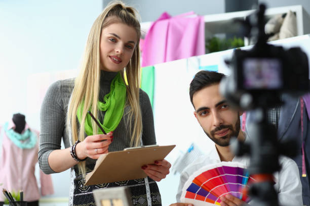 istock Two young blogger designers are broadcasting on professional camera, talking sharing tips and chatting with subscribers 1423021603