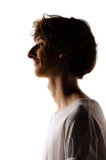 istock Side view portrait of young man with mustache posing isolated over white studio background. Silhouette 1423022264