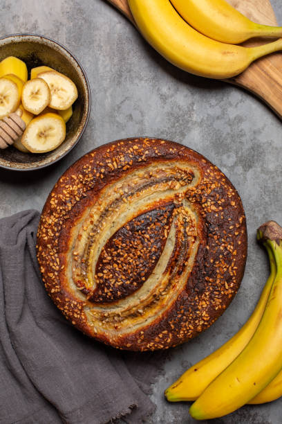 istock Banana pie and fresh bananas. Grey background, vertical image. 1423025707