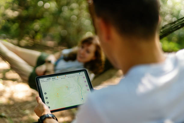 istock Millennial-aged travelers looking at a map on a digital tablet while enjoying nature 1423026374