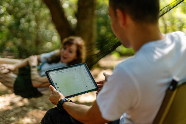 istock Millennial-aged travelers looking at a map on a digital tablet while enjoying nature 1423026376
