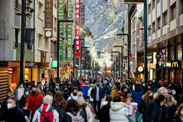 Crodws of people on a commercial street in Andorra la Vella at Christmas.