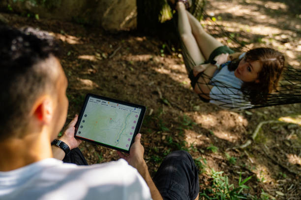 istock Millennial-aged travelers looking at a map on a digital tablet while enjoying nature 1423026629