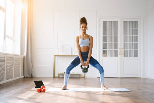 istock African american exercising with weight 1423028286