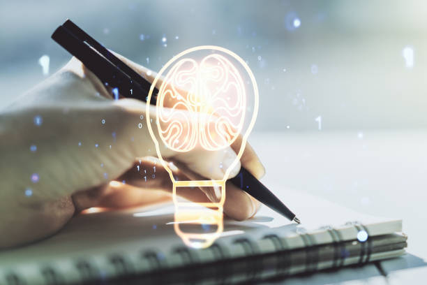 istock Creative idea concept with light bulb and human brain illustration and with woman hand writing in notebook on background. Neural networks and machine learning concept. Multiexposure 1423028602