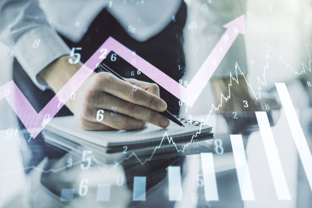 istock Abstract creative financial graph with upward arrow and man hand writing in notebook on background, forex and investment concept. Multiexposure 1423028642