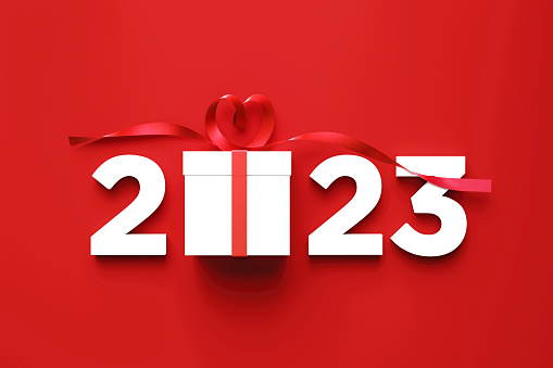 2023 and white gift box sitting over red background. Horizontal composition with copy space. Directly above. Great use for Christmas related gift concepts.