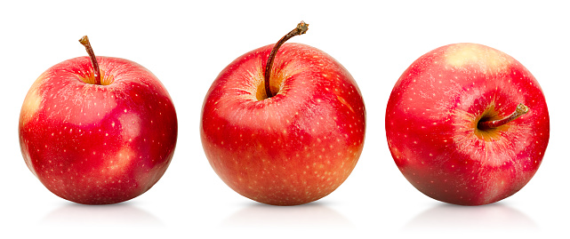 three red whole apples on a white isolated background