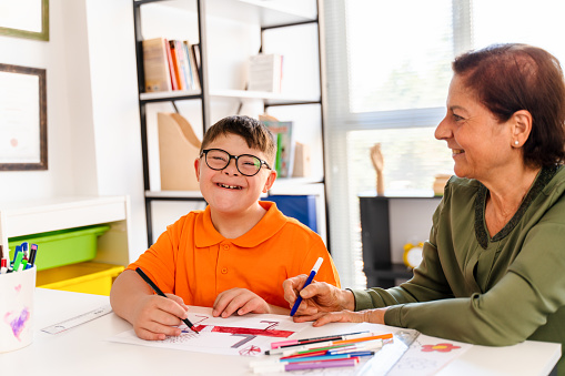 istock A boy with down syndrome is in a classroom with his teacher 1423031613