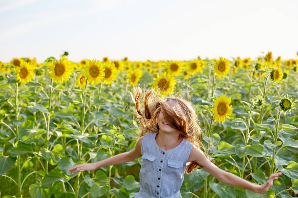 istock girl in sunflowers 1423033889