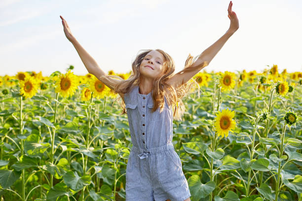 istock girl in sunflowers 1423033925
