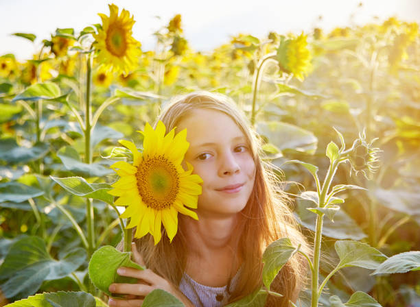 istock girl in sunflowers 1423034096
