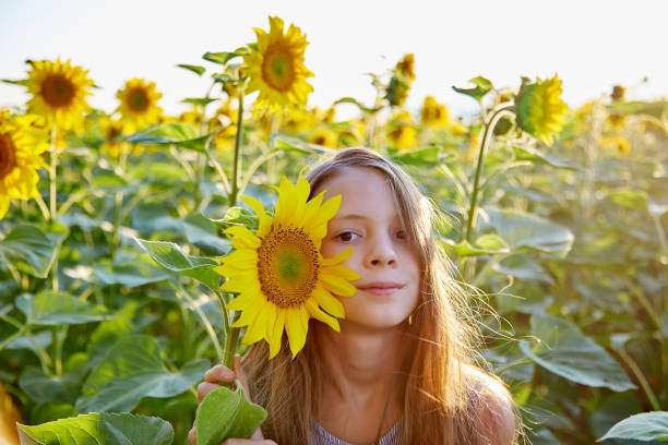 istock girl in sunflowers 1423034118