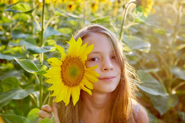 istock girl in sunflowers 1423034124