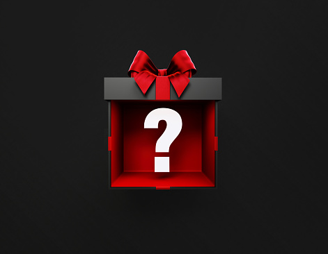 White question mark is coming out of a black gift box tied with red ribbon on black background. Horizontal composition with copy space. Directly above.
