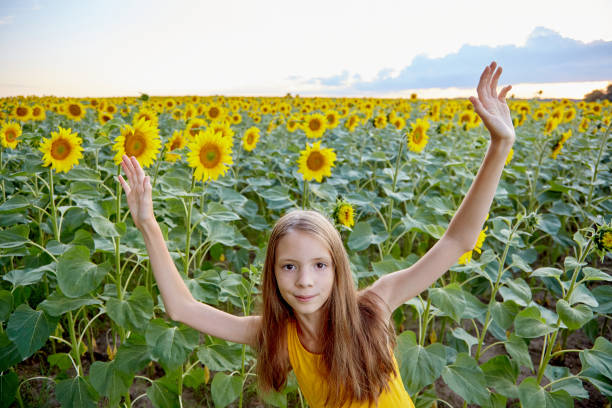 Close-Up Of Beautiful Woman Wearing Sunglasses By Sunflower