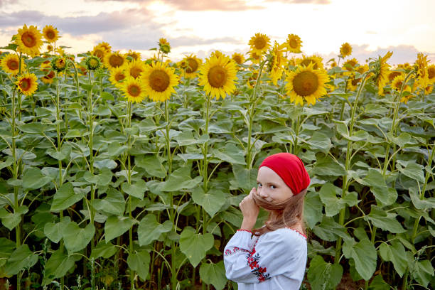 istock girl in sunflowers 1423034345