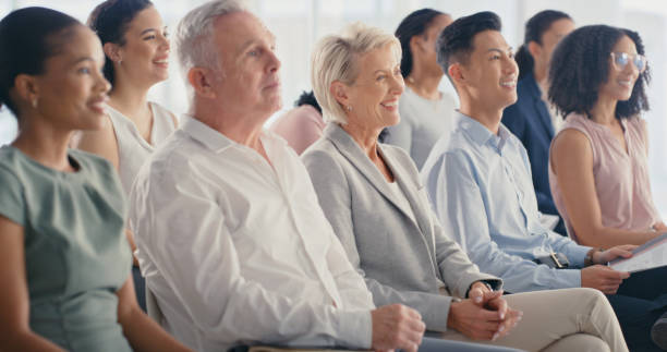 istock Work presentation, conference or tradeshow workshop with audience listening in the crowd. Diversity of trade show seminar or convention speech with happy corporate workers  learning business strategy 1423034689