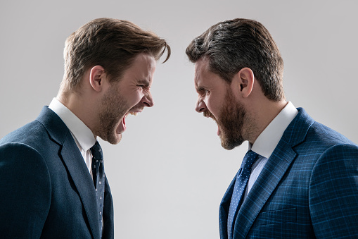 arguing businesspeople. dissatisfied men discuss failure. colleagues have disagreement conflict. shouting businessmen face to face. disrespect and contradiction. business partners blame each other.