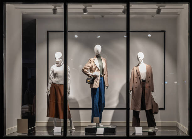 Fashion Store exterior. Shop windows and mannequins. City Night Boutique. Front View from street outdoor. LED light Shop windows and mannequins. Fashion Store exterior. City Night Boutique. Front View from street outdoor. LED light. City facade background boutique stock pictures, royalty-free photos & images