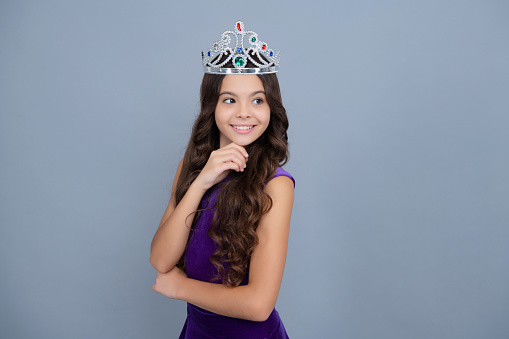 Teen child in queen crown isolated on gray background. Princess girl in tiara. Teenage girl wear diadem
