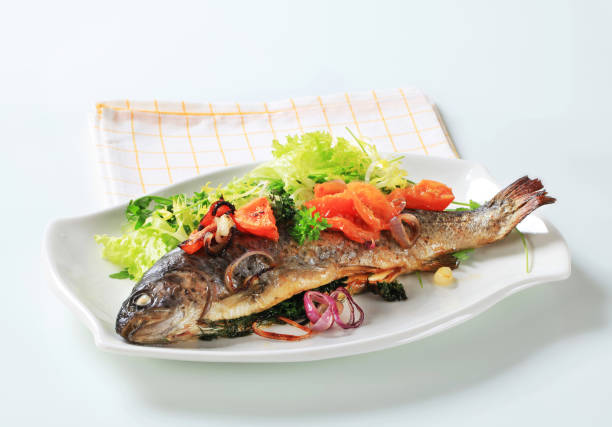 istock Baked trout with tomatoes and green salad 142303992