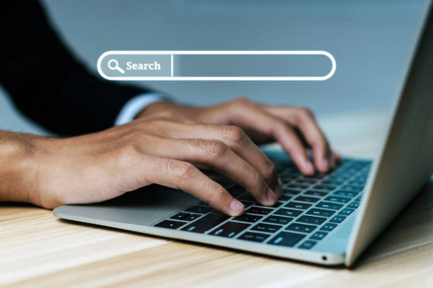 istock Website. businessman hand working on mobile laptop computer with virtual screen search button, searching browsing information, business finance, internet data technology and data search engine concept 1423040570