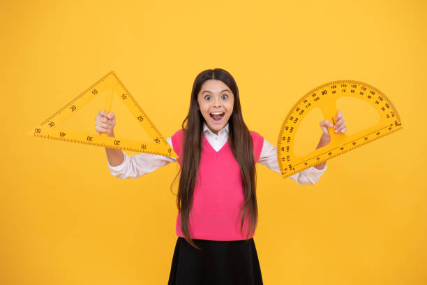 istock surprised kid girl use protractor and triangle to learn mathematics, measurement 1423041009